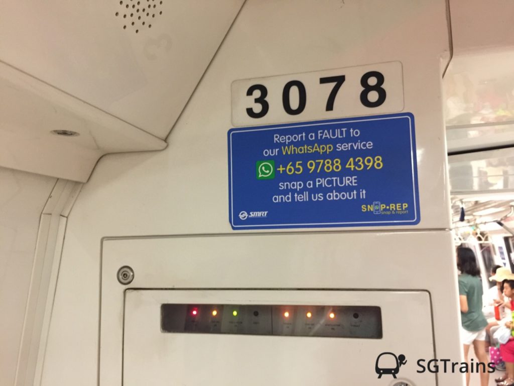 A Kawasaki Heavy Industries C151 train's interior wall with a carriage number sticker of 3078 and a sticker for SMRT SNAP-REP.