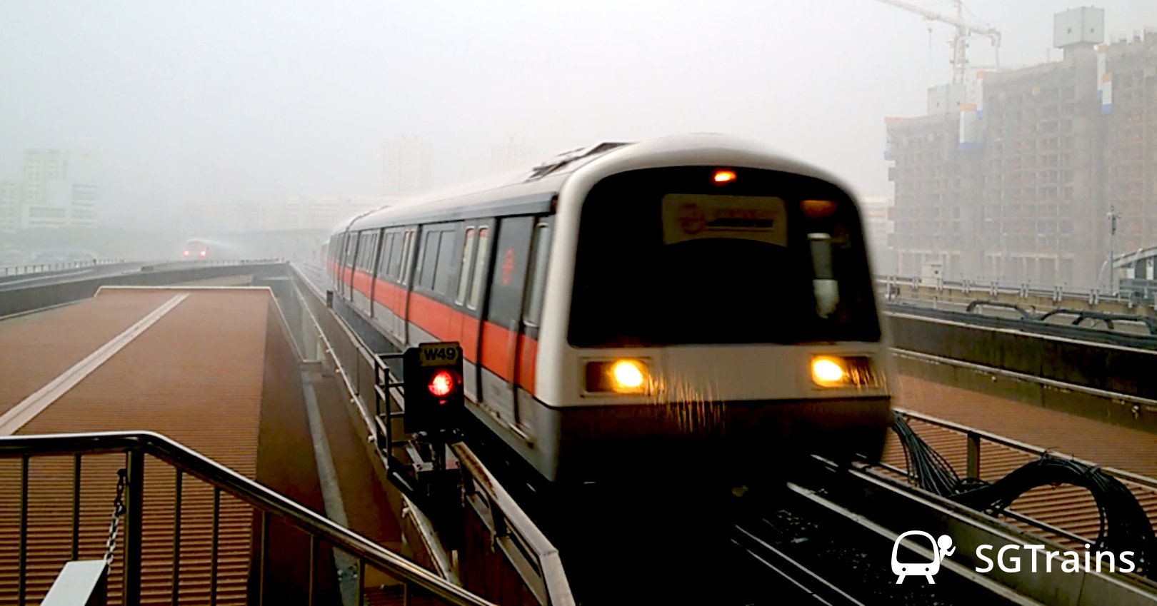An SMRT Kawasaki Heavy Industries C151 train arriving Jurong East MRT Station during a thunderstorm with a lot of rain.