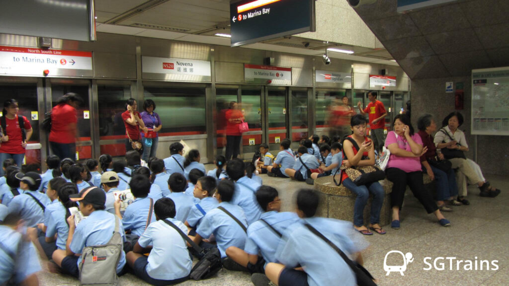 Primary School students waiting for their chartered MRT train at the station platform
