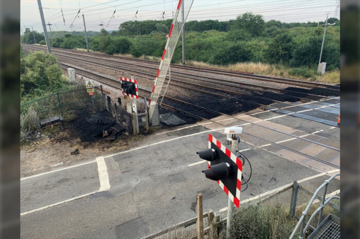 A trackside fire due to the heatwave near Sandy, Bedfordshire, has caused "major damage to signalling equipment and a level crossing", disrupting train services between Peterborough and King's Cross. (Image: Network Rail)