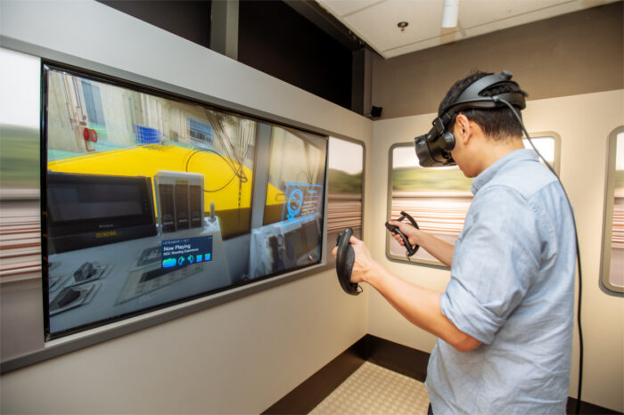 A visitor trying out the Virtual Reality (VR) experience of shunting an engineering train at a rail depot. (Photo: SMRT)