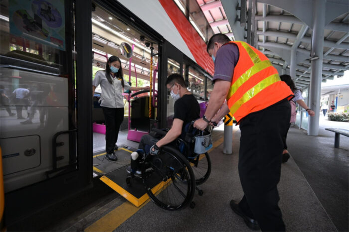 Interchange Supervisor & Travel Buddy Ms Xue Moi with wheelchair user Mr Tan. (Photo: SBS Transit/Facebook)